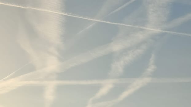 blue sky, white stripes, traces of airplane flight, air background abstract . High quality photo