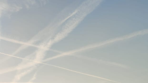 blue sky, white stripes, traces of airplane flight, air background abstract . High quality photo