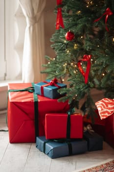 gifts under the tree, lots of gift boxes. Festive mood.