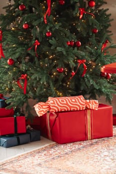 gifts under the tree, lots of gift boxes. Festive mood.