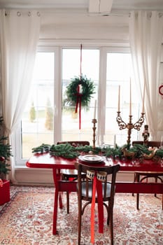Beautiful Christmas interior. A table and a Christmas tree, a festive table. decoration.