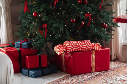 gifts under the tree, lots of gift boxes. Festive mood.