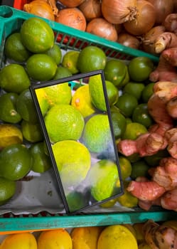 colorful assortment of kitchen fresh produce, herbs and spices featuring limes, onions, ginger, and lemons, enhanced by digital display technology, perfect for markets or healthy lifestyle concepts