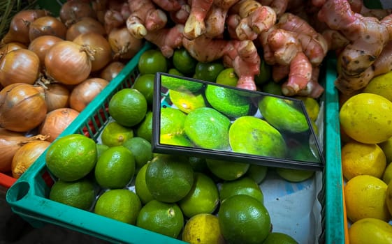 colorful assortment of kitchen fresh produce, herbs and spices featuring limes, onions, ginger, and lemons, enhanced by digital display technology, perfect for markets or healthy lifestyle concepts