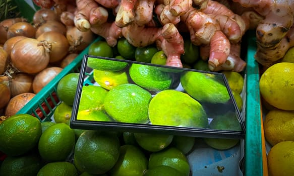 colorful assortment of kitchen fresh produce, herbs and spices featuring limes, onions, ginger, and lemons, enhanced by digital display technology, perfect for markets or healthy lifestyle concepts