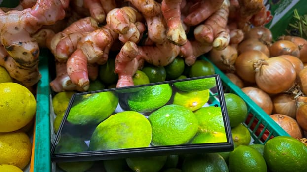 colorful assortment of kitchen fresh produce, herbs and spices featuring limes, onions, ginger, and lemons, enhanced by digital display technology, perfect for markets or healthy lifestyle concepts