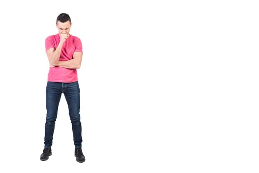 Full body of doubting male model in casual outfit standing with hand at chin and trying to solve problem on white background
