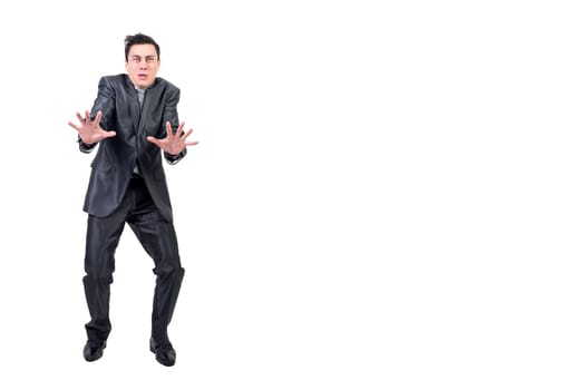 Full body of fearful man in suit showing stop gesture and looking at camera isolated on white background in studio