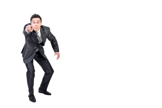 Full body of male in formal suit pointing and looking at camera isolated on white background in light studio