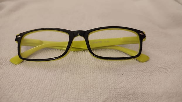reading glasses, yellow black frame, object health medicine, ophthalmologist. High quality photo