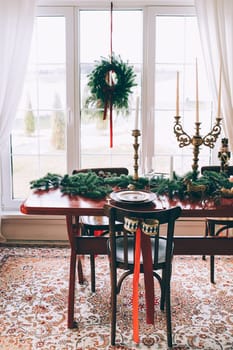Beautiful Christmas interior. A table and a Christmas tree, a festive table. decoration.