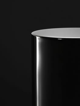 Sleek round polished black pedestal design for modern decor.