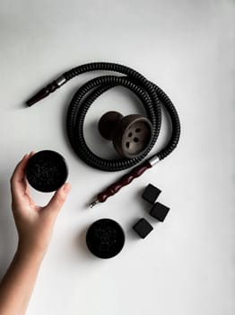 Hookah accessories set flat lay on white background wish bowl, hose and charcoal. High quality photo