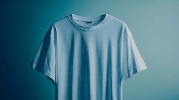 Light blue t-shirt is hanging on a turquoise background, creating a minimalist aesthetic