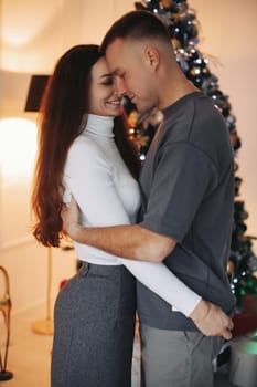 A couple of guys and a girl are beautiful and stylish, in love with the Christmas holiday.