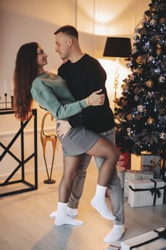 A couple of guys and a girl are beautiful and stylish, in love with the Christmas holiday.