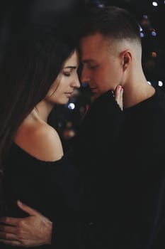 A couple of guys and a girl are beautiful and stylish, in love with the Christmas holiday.