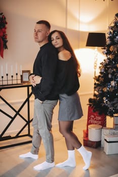 A family around the Christmas tree in the new year, a holiday with family,a beautiful happy stylish family.