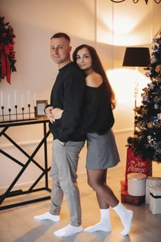 A family around the Christmas tree in the new year, a holiday with family,a beautiful happy stylish family.