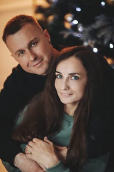 A couple of guys and a girl are beautiful and stylish, in love with the Christmas holiday.