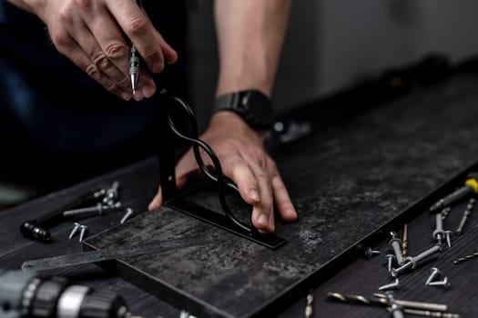 Man Makes Shelf From Board And Bracket For Attaching Hand In Close-Up
