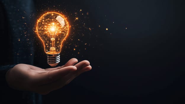 Businessman is holding a glowing light bulb, representing innovation and new ideas