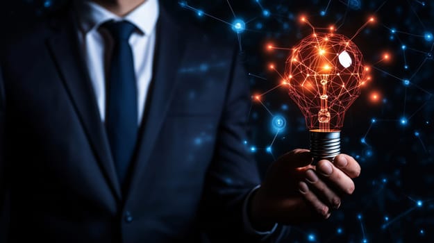 Businessman is holding a lightbulb with a network of connections, symbolizing innovation and technological advancement