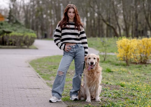 Teenage Girl Enjoys Spring Park With Golden Retriever