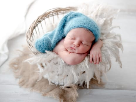 Newborn Baby Sleeps In Basket During Photo Session