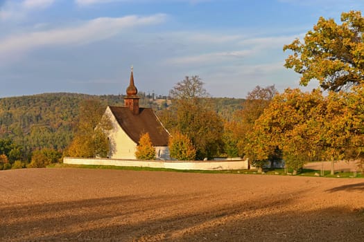 Beautiful autumn landscape with old Chapel of the Mother of God in Veveří. Sunset and beautiful blue sky with clouds. Colorful nature background on autumn season. Brno - Czech Republic.