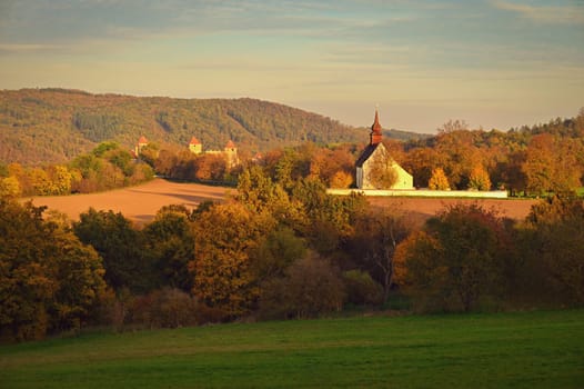 Beautiful autumn landscape with old Chapel of the Mother of God in Veveří. Sunset and beautiful blue sky with clouds. Colorful nature background on autumn season. Brno - Czech Republic.