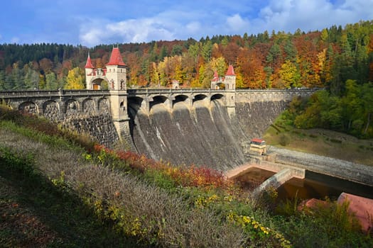 Beautiful old dam Les Kralovstvi - Czech Republic. Autumn background with colorful trees. Nature with landscape. Seasonal concept for fall.