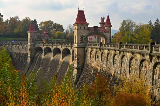Beautiful old dam Les Kralovstvi - Czech Republic. Autumn background with colorful trees. Nature with landscape. Seasonal concept for fall.