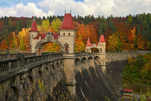Beautiful old dam Les Kralovstvi - Czech Republic. Autumn background with colorful trees. Nature with landscape. Seasonal concept for fall.