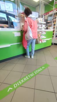 October 22 2024 Hradec Kralove, Czech Republic Europe, Kralov region, discount zone, girl buyer in pharmacy, medicines on shelf High quality photo