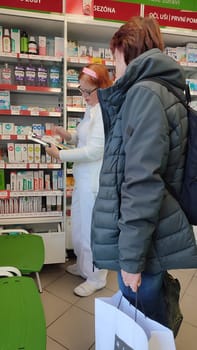 October 22 2024 Hradec Kralove, Czech Republic Europe, Kralov region, women in pharmacy Doctor Max, medicines on shelf High quality photo