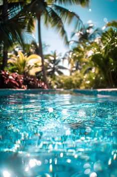 A beautiful swimming pool surrounded by palm trees under the sunlight, creating a relaxing natural landscape for leisure activities