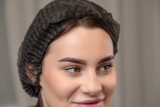 A woman with well-groomed eyebrows that enhance her natural beauty smiles confidently.