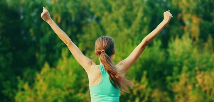 Fitness happy strong woman enjoying after training outdoors, runner winner in summer park