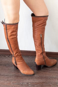 Skinny woman wearing stylish leather tight boots