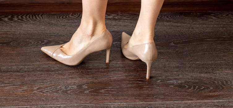 Woman wearing high heels shoes.