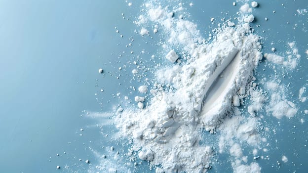 A mound of white powder resembling the ocean foam rests on a vibrant electric blue surface, evoking memories of underwater adventures and marine biology exploration