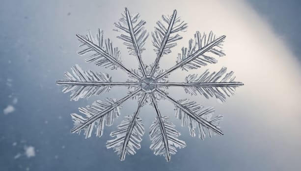 A stunning snowflake exhibits intricate patterns as it sparkles in the soft light of winter. The cool blue backdrop enhances its delicate beauty, capturing a serene moment.
