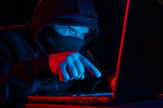 Computer Hacker in Hoodie. Obscured Dark Face. Hacker Attack, Virus Infected Software, Dark Web and Cyber Security Concept .