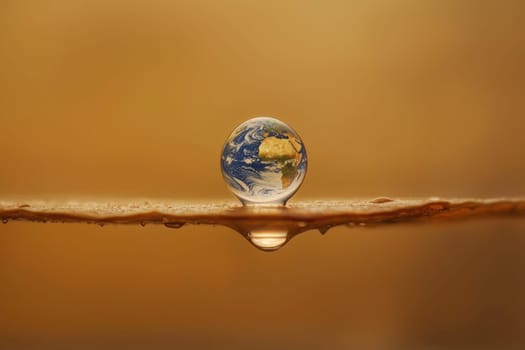 A single droplet of water sits flawlessly on a surface, showcasing a perfect spherical shape and reflecting the surrounding colors, evoking a sense of tranquility and beauty.