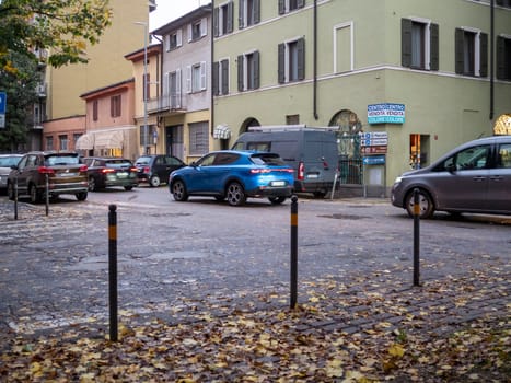 Cremona, Lombardy, Italy October 15th 2024 An alfa romeo tonale passing through a crossroad in a residential area with fallen autumn leaves on the ground