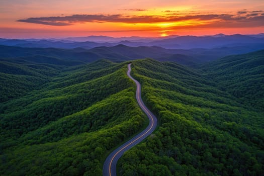 Scenic view of a winding road leading through lush green hills against the backdrop of majestic mountains on a sunny day..