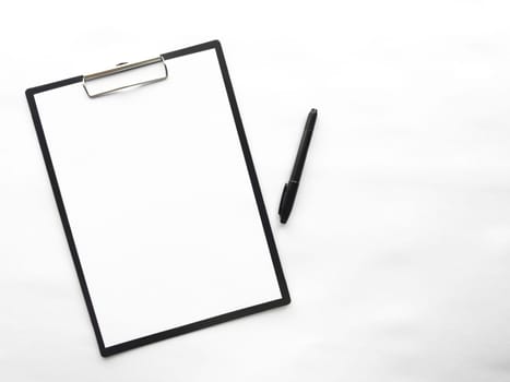 Minimalist clipboard with blank paper and pen on white background.