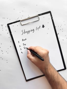Creative shopping list on clipboard surrounded by silver stars.