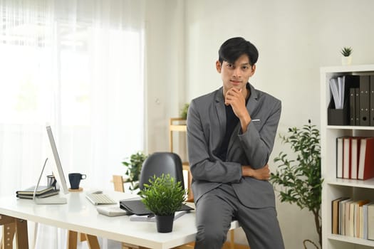 Portrait of confident businessman posing in a modern office.